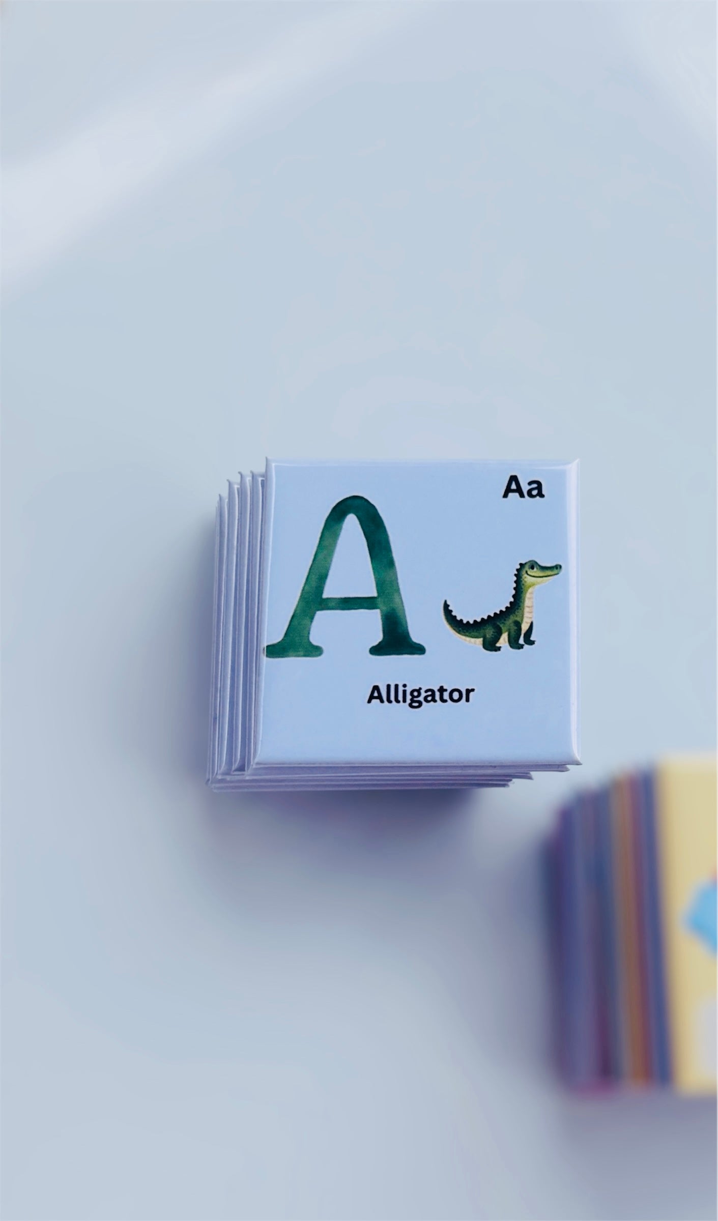 A stack of handmade alphabet photo magnets.
