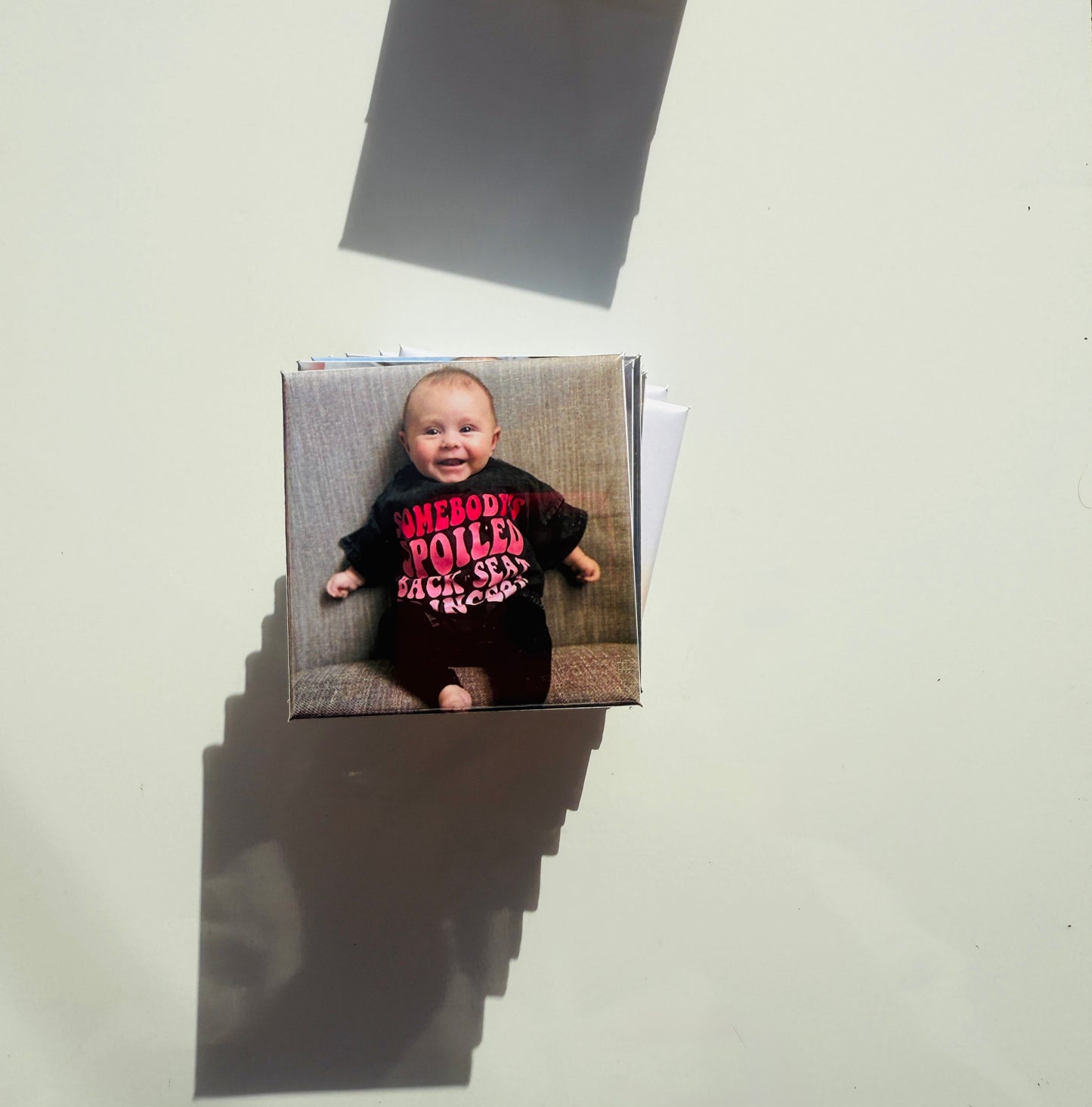 Personalized baby photo magnet with a smiling infant in a funny shirt, perfect for milestone keepsakes and gift sets.

