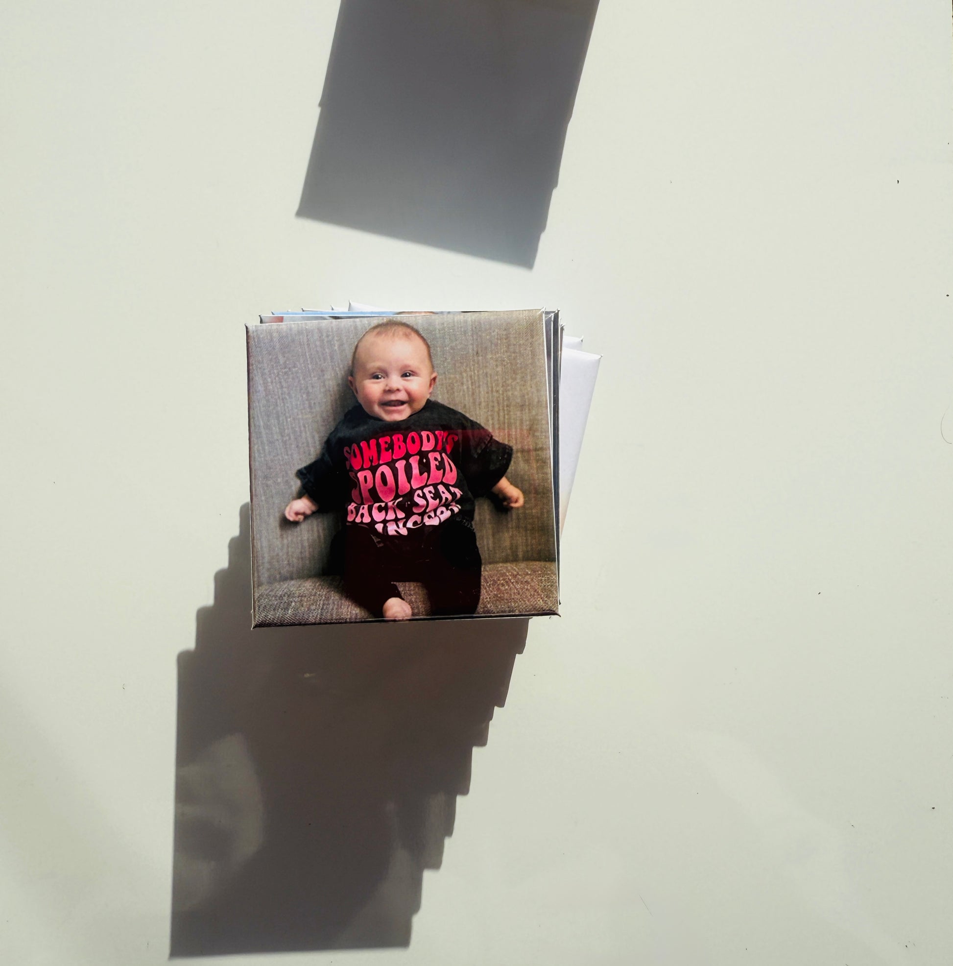 Personalized baby photo magnet with a smiling infant in a funny shirt, perfect for milestone keepsakes and gift sets.

