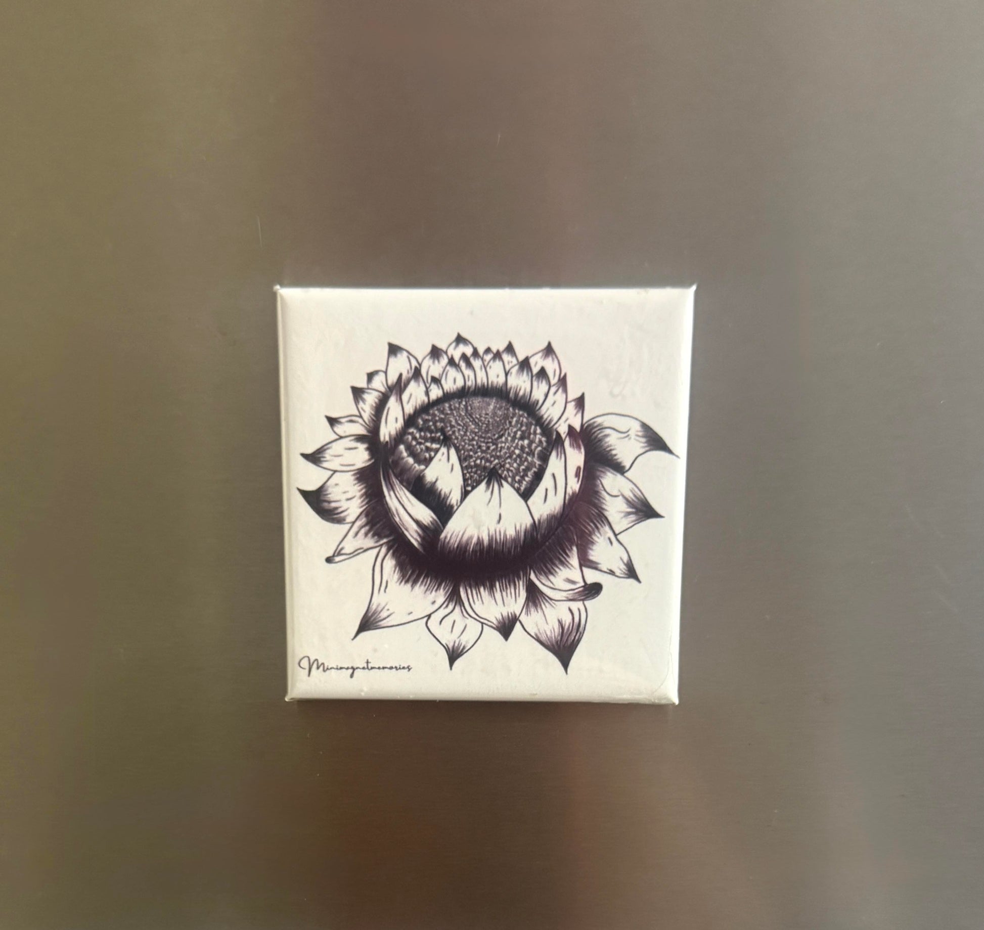 Black and white artistic magnet featuring a hand-drawn lotus flower design with mountains inside.