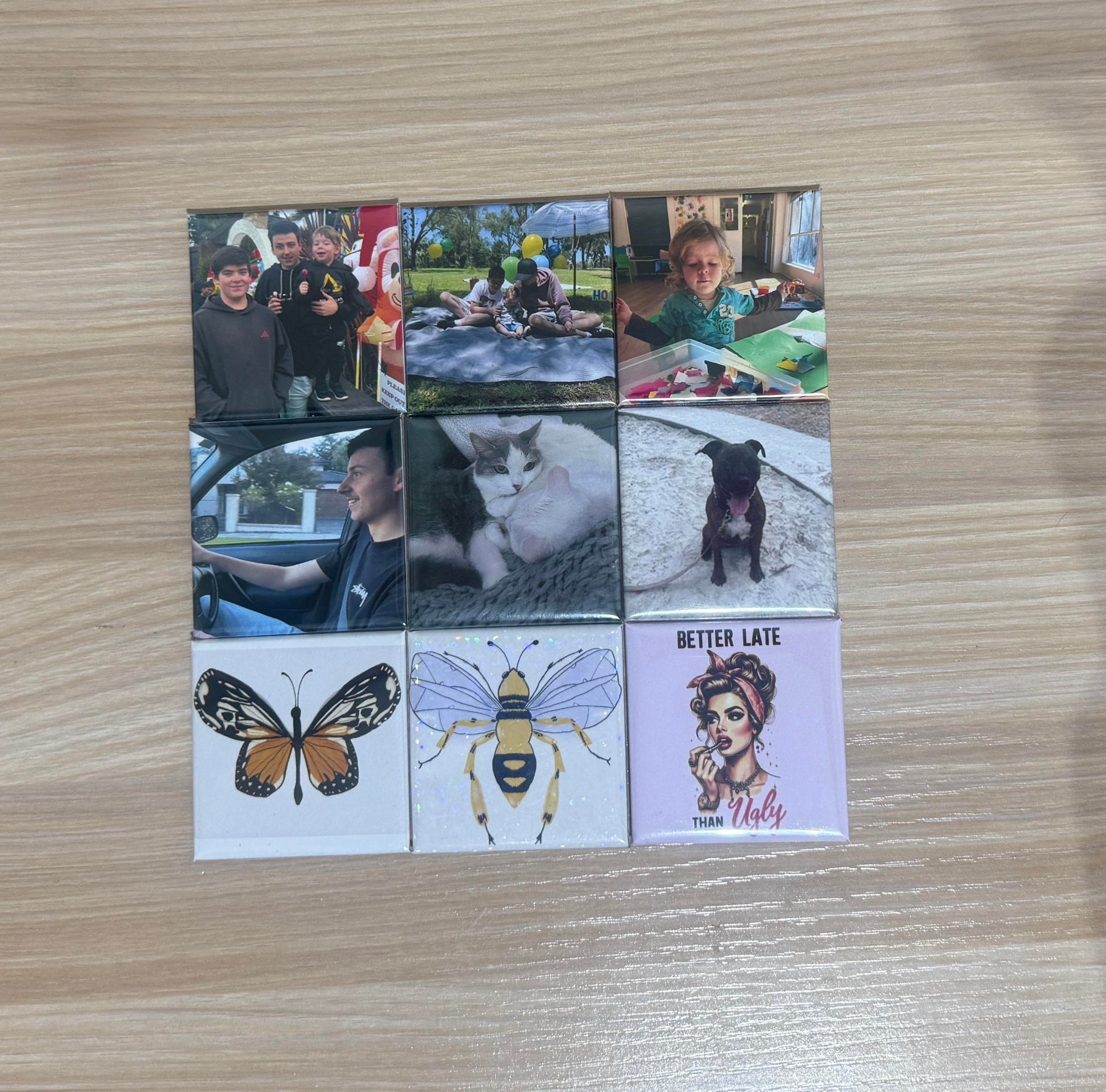 A set of custom photo magnets featuring family moments, pets, and artistic designs on a wooden surface.