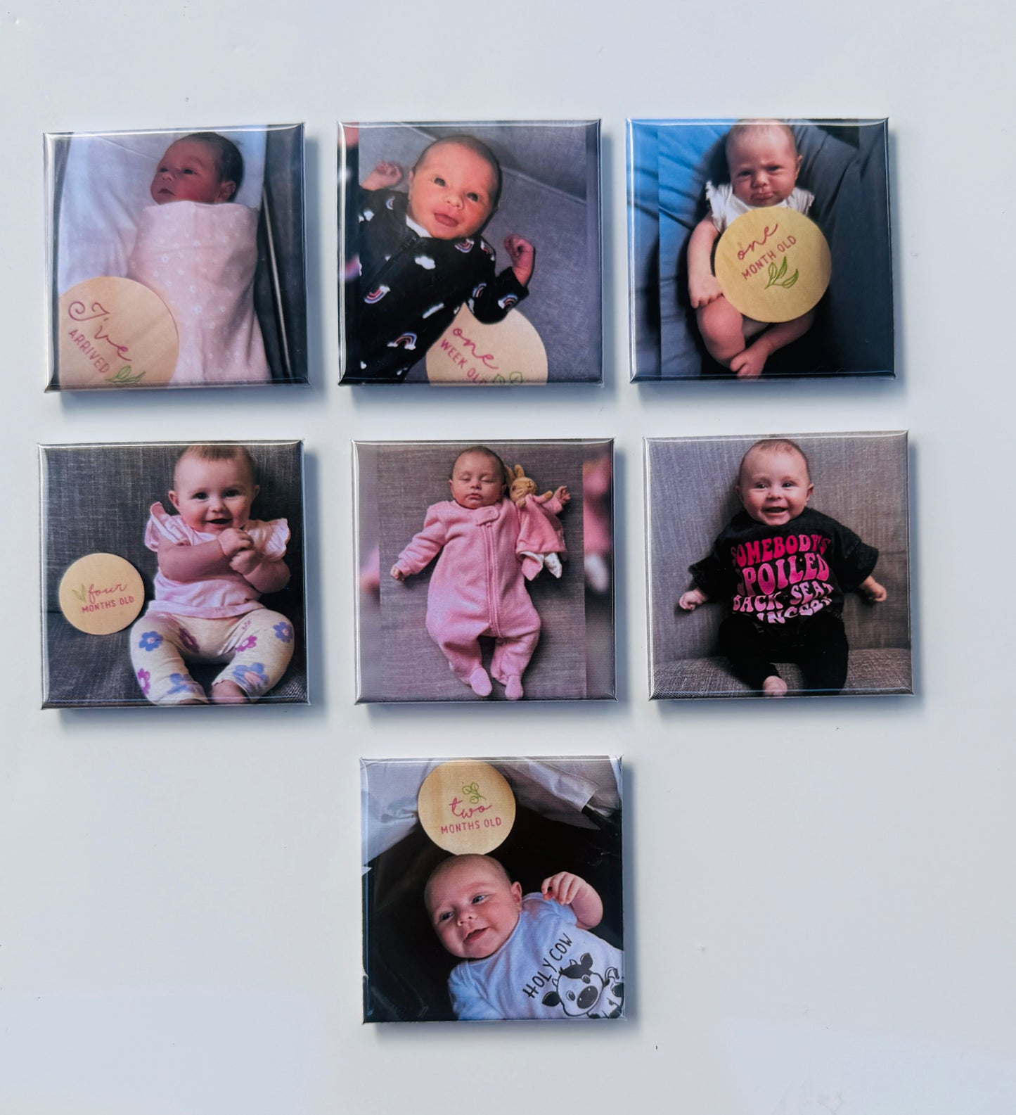 Milestone baby photo magnets showing a baby’s growth from birth to two months old.