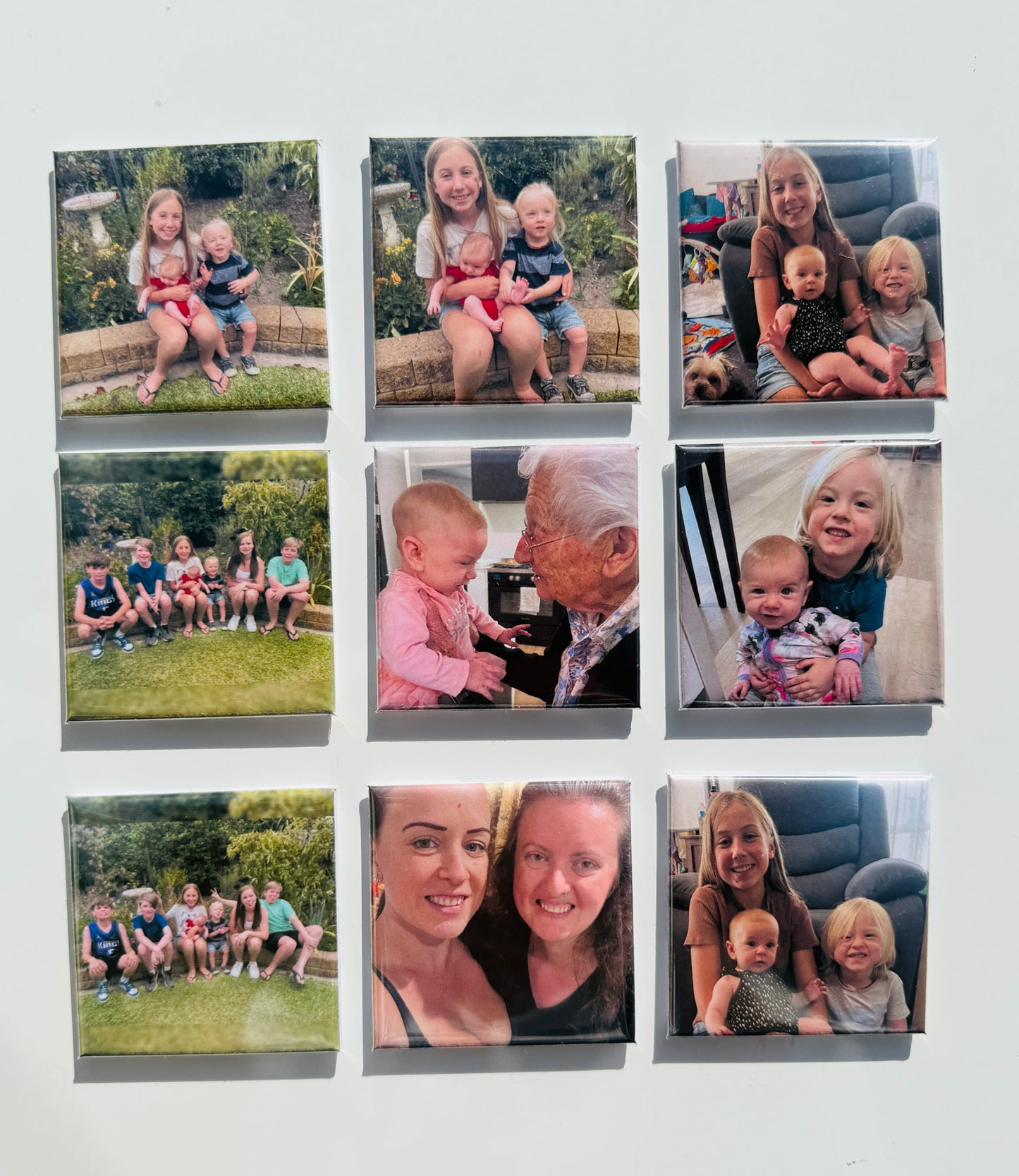 Custom photo magnets displayed on a light background, made from baby, family,  – available in sets of 9 to 24.
