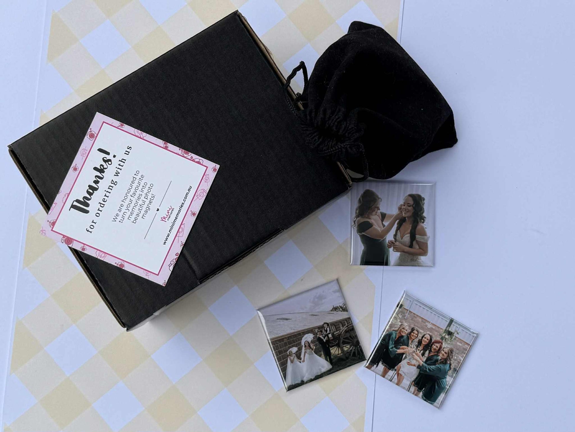 3 photo magnets with images of people and a velvet pouch with thank you card and gift box.
